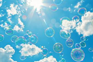 Soap bubbles floating against a bright blue sky with sun rays and clouds