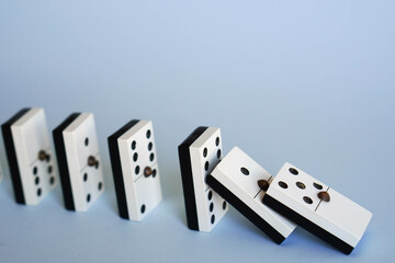Fototapeta na wymiar falling dominoes, chain reaction, domino effect or butterfly effect concept