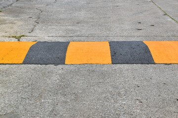 speed bump on concrete road, traffic warning signs to drive vehicle slow down
