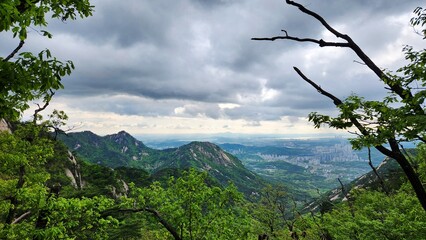 the top of Bukhansan Mountain in Korea in cloudy weather. hiking in korea. dark rain clouds hover...