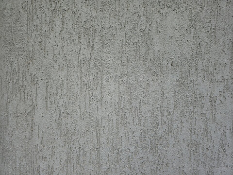 Betonowa, tynkowana szara ściana z widoczną fakturą, chropowata