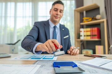 Businessman stamping a document with a rubber stamp.