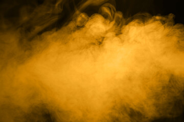 golden smoke steam spray, and abstract vapor water isolated on a black background. concept of...