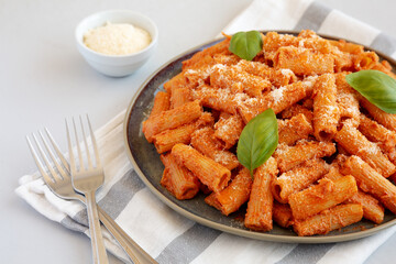 Homemade Vodka Rigatoni Pasta with Parmesan and Basil, side view.