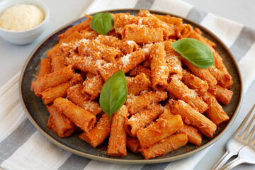 Homemade Vodka Rigatoni Pasta with Parmesan and Basil, side view.