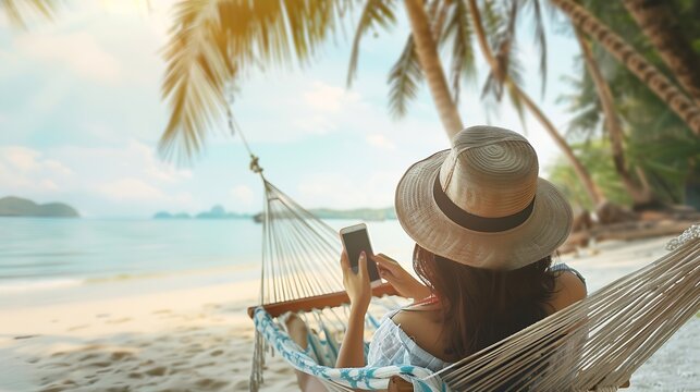 Summer travel vacation concept Happy traveler asian woman using mobile phone and relax in hammock on beach in Koh Chang Trad Thailand : Generative AI