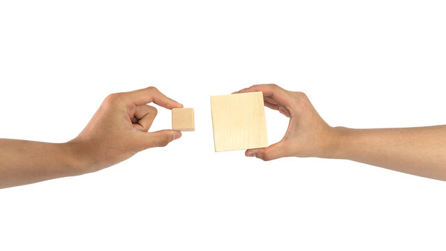 Hand holding wooden block isolated over white background, Wooden square cube in hand isolated on the white