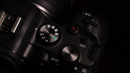 Photography shooting modes digital SLR camera with different buttons and roulettes nearby