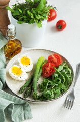 Fresh Spring Salad With Boiled Eggs, Asparagus, and Tomatoes on a Bright Day
