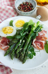Fresh Asparagus and Prosciutto Salad Served With Boiled Eggs and Microgreens