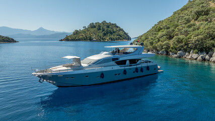 Fototapeta premium 01.02.2024 Oludeniz - Turkey: Aerial drone photo of beautiful yacht at deep blue Aegean sea near island