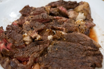 Medium rare sliced sirloin meat on the white cutting board