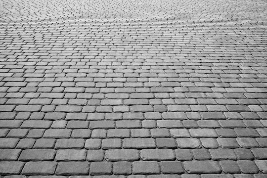 Stone pavement texture in perspective. Abstract background of old cobblestone pavement.