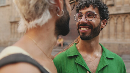 Close-up of gay couple laughing while standing on street of old city
