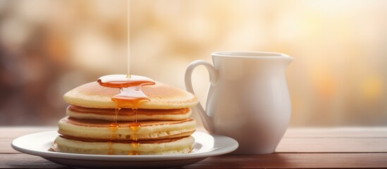 Enjoying a delightful breakfast of fluffy pancakes accompanied by a steaming cup of coffee. Copyspace image