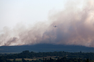 Bombardier Q400 water bomber in action over the fire in the Monts d'Arrée