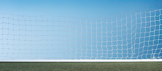 A soccer goal corner with a white net and a sky blue background ready for a copy space image