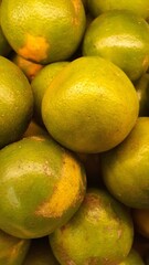 Close up pile of tasty fresh oranges sold at the market as a background.