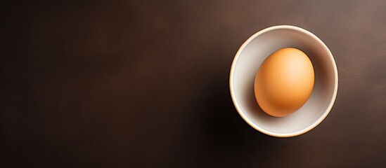 A bird s eye view of an egg resting in a bowl with ample copy space image - Powered by Adobe