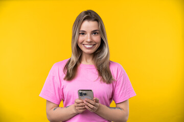 Happy emotions concept. Positive and beautiful young woman in studio with phone