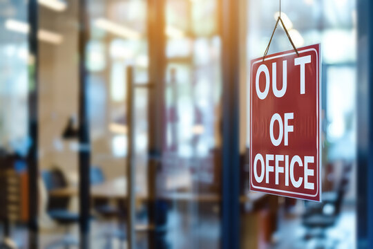 sign "Out Of Office" with blurry background of an office