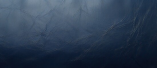 A copy space image featuring a genuine looking synthetic leather background with a rich deep blue hue and textured appearance