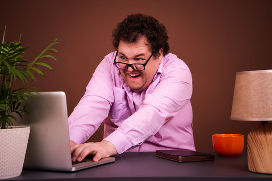 Funny man watches adult films on a laptop at home.