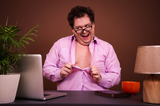Funny man watches adult films on a laptop at home.