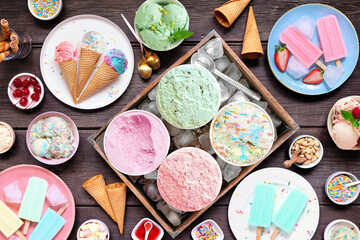 Cool summer food table scene. Assortment of ice cream, popsicles and frozen treats. Pastel colors....