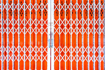 Abstract background, stretched metal door Exterior design and decoration of bright orange steel...