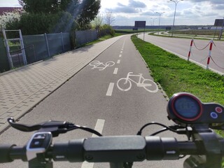 Electric scooter on the bike path. First-person view