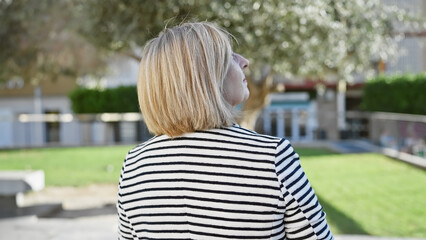 Blonde woman, mature, outdoors, casual, thoughtful, park, day, lifestyle, striped, leisure