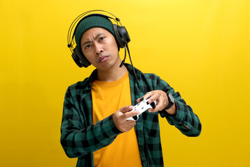 A bored Asian man, dressed in a beanie hat and casual shirt, appears disinterested while playing...