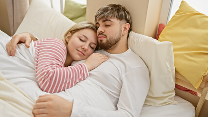 A tranquil couple embraces while sleeping in a cozy bedroom, depicting love and comfort in an indoor setting.