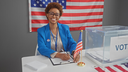 A smiling african american woman in a blue blazer taking notes at an indoor united states electoral...
