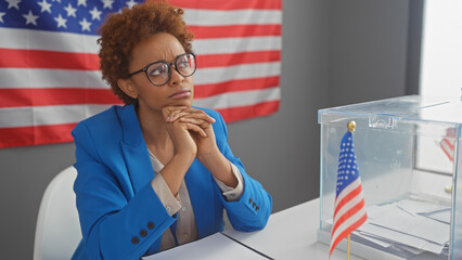 Pensive african american woman indoors with electoral ballot and us flag