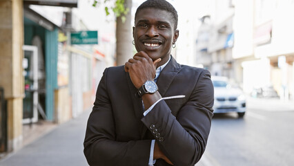 Confident african man in a stylish suit standing on an urban city street.
