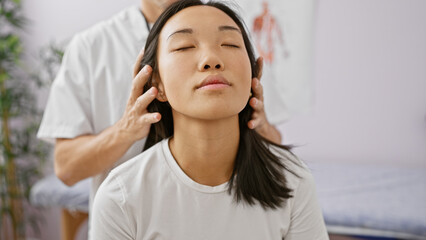 A woman receiving neck therapy from a male physiotherapist in a well-lit rehabilitation room