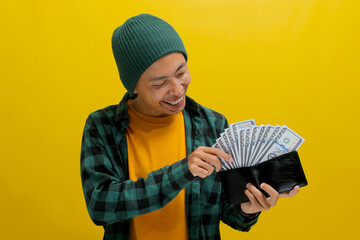 Thoughtful Asian man holds a wallet filled with cash contemplating how to spend it wisely, focusing on potential investments and ways to increase earnings. Business, finance, and saving money concept