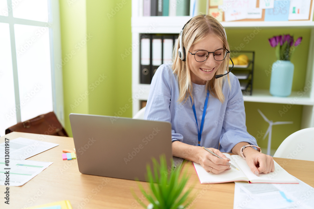 Sticker young blonde woman call center agent smiling confident writing on notebook at office