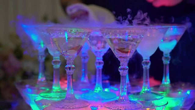 Tower of glasses at celebration party. Welcome drinks, tower of champagne or sparkling wine. Empty with red berry. Restaurant ready for reception. Alcoholic beverage.