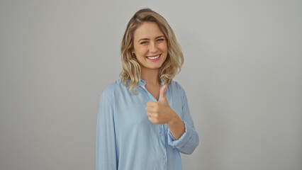A cheerful young woman with blonde hair gives a thumbs-up against a white background.
