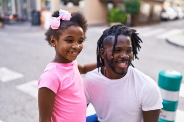 Father and daughter smiling confident standing together at street