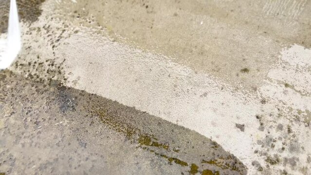 Outdoor floor cleaning with a high pressure washer