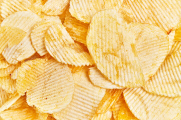 Close-up of crisp, golden potato chips filling the frame, perfect for snacking themes