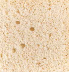 Close-up texture of white bread showing detailed porous structure suitable for food and baking...