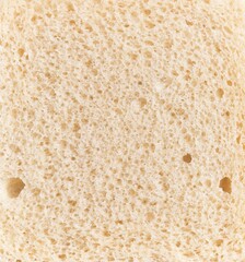 Close-up texture of a sliced white bread highlighting its porous structure and baked color.