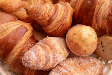 Close-up on bakery - various kinds of breadstuff. sweet bakery products, muffin  and croissant