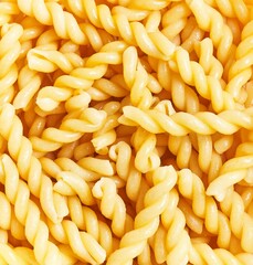 Close-up texture of fusilli pasta with no people, ideal for background or food-related content.