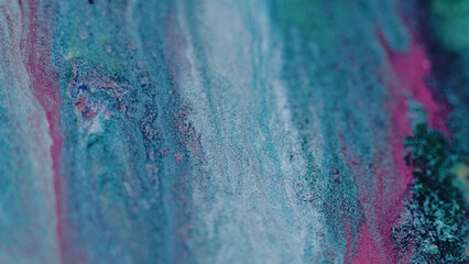 Paint spill. Glitter ink flow. Defocused blue pink color sparkling metallic liquid pouring blend...